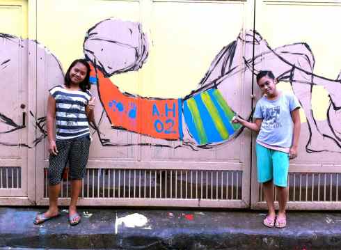 Two of the talented artists who collaborated with me on the Bahay Tuluyan mural, with their work